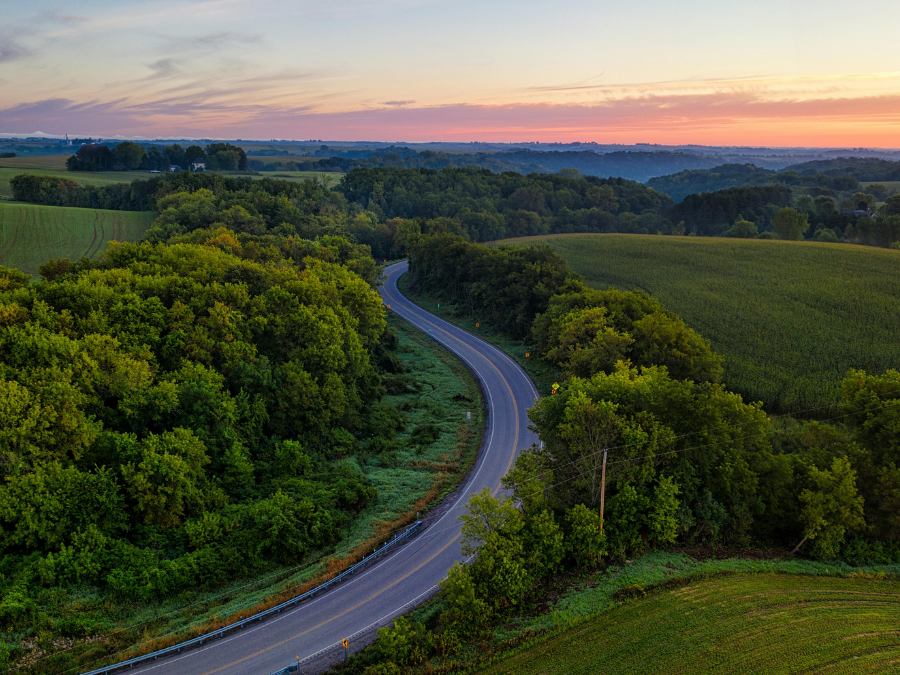 Winding Iowa country road at sunrise